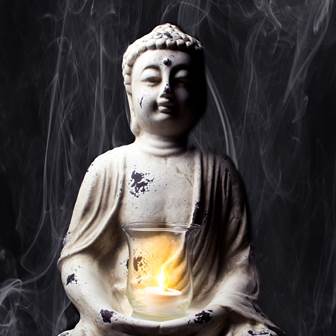 Buddha statue with candle
